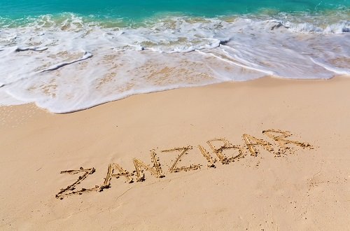 Sign,Zanzibar,On,The,Beach,With,Turquoise,Water,,Zanzibar,,Tanzania